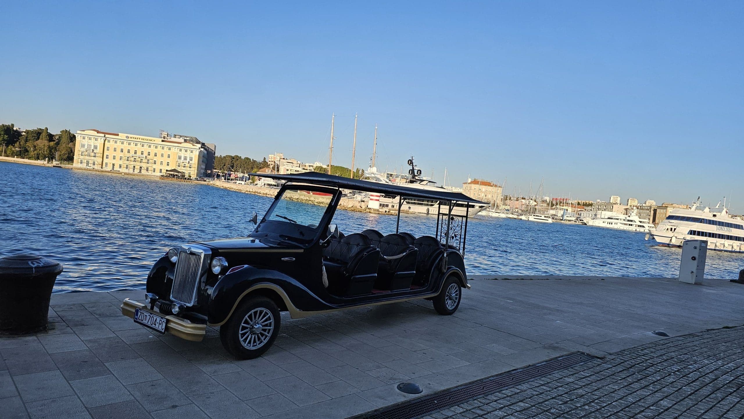 Electric tuk tuk parked on the Zadar waterfront promenade